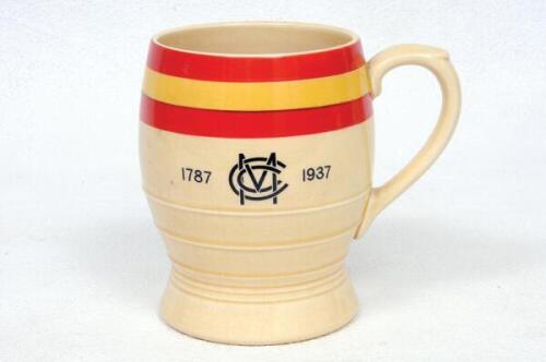 M.C.C. 1787-1937. '150th Anniversary of the Marylebone Cricket Club'. Minton cream ware ceramic tankard produced to commemorate the event in 1937. M.C.C. colours of red and yellow in bands to top of the tankard with 'M.C.C. 1787-1937' inscribed below to b