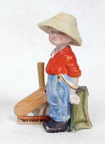 'Out First Ball'. Kinsella caricature spill vase of a young boy looking disappointed with broken wicket behind him. Printed title below wickets and bat. German circa early 1900's. 5.5&quot;. Some very minor wear otherwise in good condition - cricket