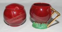 Sylvac cricket ceramic ceramics etc. Sylvac ceramic red cricket ball shaped jam pot/sugar bowl with lid. No 4714. Plus Sylvac ceramic red cricket ball shaped mug with stump handle. No 4720. Sold with five similar coloured items which are more modern, mat