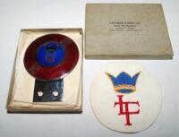 Lord's Taverners car badge. Enamelled metal car badge by Fattorini &amp; Sons, Birmingham, in the form of a cricket ball with red background and initials 'L.T.' below a crown on a central blue enamel roundel. The badge measures approx. 3&quot;x4&quot;. So