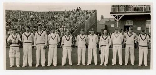 H.D.G. Leveson-Gower's XI v Australians, Scarborough 1947. Original mono photograph of the Leveson-Gower XI standing in one row wearing cricket attire in front of the pavilion, for the match played 8th- 10th September 1948. Players are Robins (Captain), H