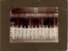 Eton College 1914. Two original mono photographs of teams standing in one row wearing cricket attire, in front of the pavilion at Agar's Plough, Eton College. Both photographs annotated in pencil to lower border, 'Eaton [sic] 1914'. Each photograph measur