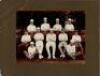 Eton College 1914. Two original mono photographs of teams standing in one row wearing cricket attire, in front of the pavilion at Agar's Plough, Eton College. Both photographs annotated in pencil to lower border, 'Eaton [sic] 1914'. Each photograph measur - 3