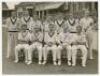 Lancashire C.C.C. 1950 County Championship joint winners. Official mono press photograph of the Lancashire team seated and standing in rows wearing cricket attire, the Old Trafford pavilion and spectators in the background. Very nicely and uniformly signe