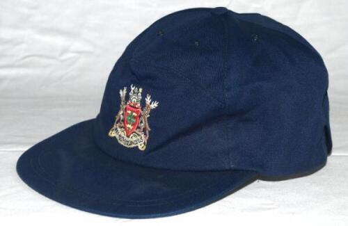 Kevin Saxelby. Nottinghamshire 1978-1990. Navy blue baseball style cap with Nottinghamshire coat of arms to front, issued to and worn by Saxelby in his playing career. Signed in ink to inside by Saxelby and sold with a signed note of authentication. Sligh