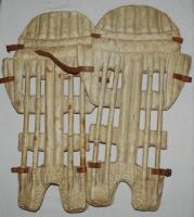 'Skeleton Leg Guards'. Pair of original late 19th century open ribbed (skeleton) cane and leather cricket pads with side flaps, possibly wicketkeeping pads. Some wear and staining, loss to some leather straps, otherwise in good condition - cricket