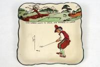 Royal Doulton 'Golfing series' 1911-1932. A square bowl with scalloped edge, decorated in colour with cavalier figures (Charles Crombie) playing golf with inscription 'Give losers leave to speak and winners to laugh'. Colour golf course border to top bord