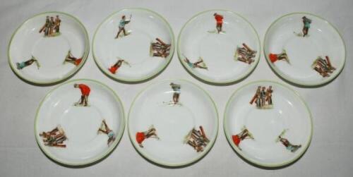 Alfred B. Pearce and Henry Williamson &amp; Son of London. Golf Series. Collection of seven golfing saucers, each with three figures of a golfer/caddies in action with light green rims. Sic saucers by Pearce. Makers stamps and reg 480949 to base. 5&quot; 