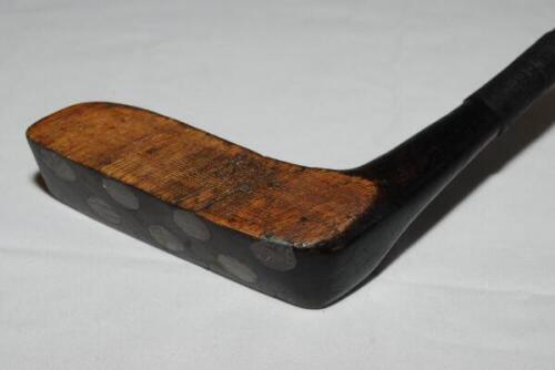 Walter Travis G6 Block Putter c.1905. The wooden head with indistinct stamp, fine groove decorations, inset with eleven lead weights. Square shaped handle and shaft with leather grip. A nice example. Good condition - golf<br><br>Walter Travis won the U.S.