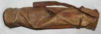 Golf bag in olive coloured leather with carrying strap and umbrella strap c.1915. Maker unknown. Lacking original carrying handle. The leather in generally good condition - golf