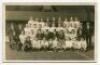 Tottenham Hotspur F.C. 1919/20. Mono real photograph postcard of the team, officials and directors, standing and seated in rows with the League and Combination trophies. Publisher unknown, probably W.J. Crawford. Postally unused. Good/very good condition.