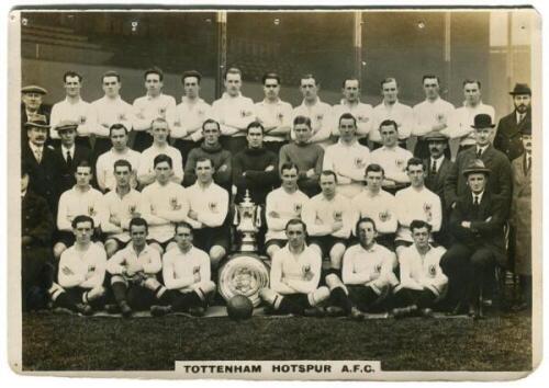 'Tottenham Hotspur A.F.C. 1921-22'. Phillips 'Pinnace' premium issue cabinet size sepia real photograph trade card of the playing staff, manager, trainers and directors, standing and sitting in rows, in front of the stand displaying the English Cup and th