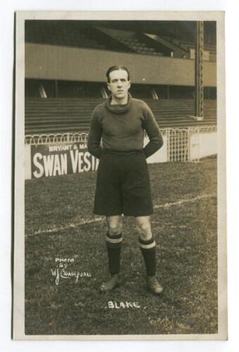 Herbert Blake. Tottenham Hotspur 1921-1923. Mono real photograph postcard of goalkeeper Blake, full length, in Spurs jersey with stand behind. W.J. Crawford of Edmonton. Postally unused. Slight silvering to image otherwise in good/very good condition - fo