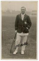 John Berry 'Jack' Hobbs. Surrey &amp; England, 1905-1934. Mono real photograph postcard of Hobbs full length wearing England blazer and holding a bat at the wicket. Very nicely signed in black ink by Hobbs. Publisher unknown. G/VG - cricket