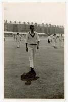 Barry Rolfe Knight. Essex, Leicestershire &amp; England 1955-1969. Mono plain back real photograph postcard of Knight, wearing M.C.C. sweater, walking off the field at Scarborough with teammates in the background. Date and publisher unknown. VG - cricket