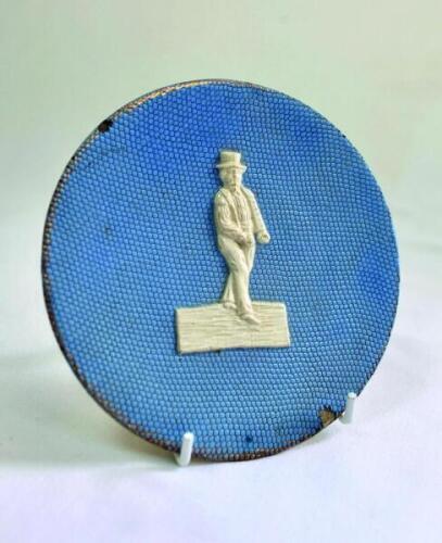 William Clarke, Nottinghamshire &amp; All England XI. Early Staffordshire style circular wall plaque with raised image of Clarke to centre in white with a light blue ground. Some gold lustre to edge. Name of 'T. Fredley' stamped to back of the plaque. The