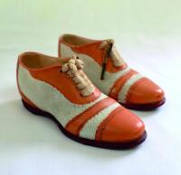 Victorian ceramic cricket shoes. A pair of beautifully sculptured miniature ceramic cricket shoes, circa 1900 (or earlier), no maker's mark noted. The exquisite shoes, measuring 5&quot; long, in white canvas and leather uppers with red soles and real lace