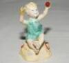 'Sunshine Days'. Modelled by F.G. Doughty. Royal Worcester figure of a girl on a beach holding a cricket ball, spade and bucket to each side of her. From the 'Worcester Children' series 1982. 3.75&quot; tall. VG - cricket