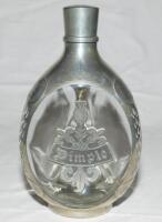 E.W. 'Jim' Swanton. Glass and pewter 'Haig Dimple' whisky decanter with 'Dimple' motif pewter panel to one side, with floral decorations, 'Haig', and coats of arms to sides. Maker's mark for Daalderop Royal Holland Pewter, no. N4919 to base. 8.5&quot; tal