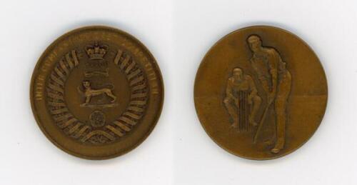 Army cricket medal. A large brass coloured metal medal inscribed to one side 'Inter Company Cricket Competition' with emblem that appears to be for the Royal Hampshire Regiment and inscription 'India'. To verso, raised figures of a batsman and wicketkeepe