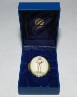 'W.G. Grace'. Halcyon Days oval enamelled pill box. The lid decorated with full length figure of Grace by 'Spy', biographical details of Grace to the inside of the lid, the inside base with inscription, 'W.G. Grace, 1848-1915. Hero of English Cricket'. St