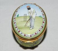 'W.G. Grace'. Halcyon Days oval enamelled pill box. The lid decorated with full length figure of Grace in batting pose wearing M.C.C. cap, history of cricket details to the inside of the lid 'Played in England since the 13th century...', the inside base w