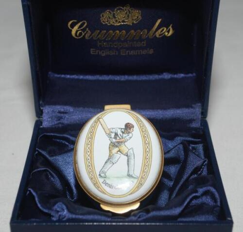Cricket pillbox. Denis Compton. Modern enamelled oval pillbox hand decorated with a portrait of Compton in batting pose. Crossed bat, pad and ball to inside lid. In original box with certificate of authentication. Produced by Crummles. VG - cricket