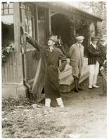 Claude George Bowes-Lyon, 14th Earl of Strathmore, Lord Glamis. Original mono press photograph of the Earl of Strathmore posting the score on the scoreboard of a country cricket pavilion, with players and spectators looking on. Pencil inscription to verso