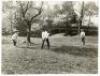 'The Negro &quot;Slave&quot;'. Original mono press photograph of three boys playing cricket in a garden setting, described by the pencil inscription to verso as' Jack Simla the black boy who ran away from his master Mr. de Jaas of Naphill nr. High Wycombe