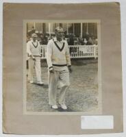 Hedley Verity. Yorkshire &amp; England 1930-1939. Excellent large original sepia press photograph of Verity walking on to the field for England v Australia at Lord's in 1934. Signed in black ink to the photograph 'Yours truly, Hedley Verity'. Handwritten 