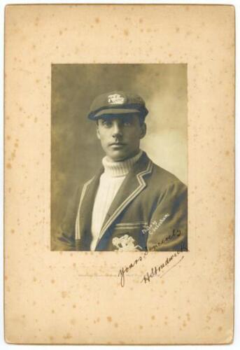 Herbert 'Bert' Strudwick. Surrey &amp; England 1902-1927. Original sepia studio portrait of Strudwick, three quarters length wearing his England cap and blazer. The photograph, laid to photographer's mount, is very nicely signed in black ink to the image 