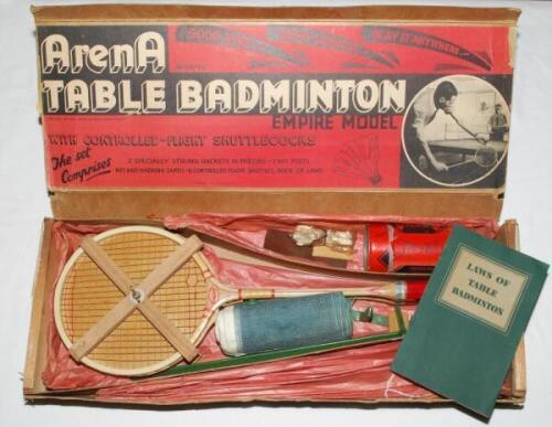 'Arena Table Badminton. Empire Model' c.1930. Set in original box with two rackets in presses, net and posts, marking tape, six shuttlecocks with feather flights in original tube, book of laws of badminton. All contained in original wood and card box. Con