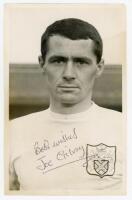 Joseph 'Joe' Gilroy. Montrose, Clyde, Fulham etc. 1958-1974. Mono Fulham F.C. Supporters Club post card size real photograph of Gilroy, head and shoulders, wearing Fulham shirt. Signed in black ink to the photograph by Gilroy. Very minor creasing, otherwi