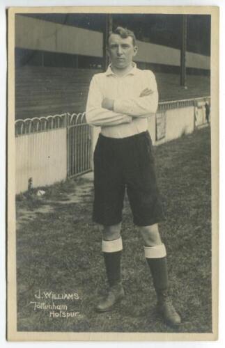 Jack L.J. Williams. Tottenham Hotspur 1912-1913. Mono real photograph postcard of Williams, full length in Spurs attire in front of the main stand. F.W. Jones of Tottenham. Some silvering to image otherwise in good condition - footballJack Williams played