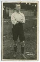 Norman Arthur Wood. Tottenham Hotspur 1908-1909. Mono real photograph postcard of Wood, full length in Spurs attire in front of the main stand. Jones Bros of Tottenham. Minor wear to card edges otherwise in good condition - footballNorman Wood appears to 