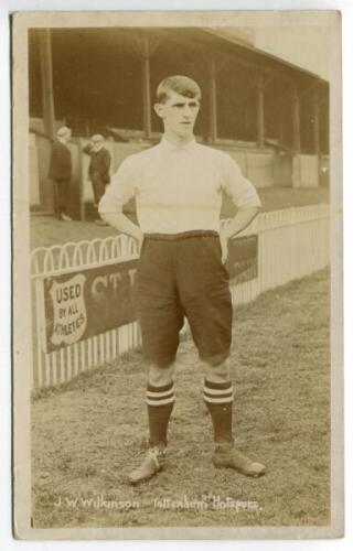 J.W. Wilkinson. Tottenham Hotspur 1906-1907. Sepia real photograph postcard of Wilkinson, full length in Spurs attire, in front of the main stand. Jones Bros of Tottenham. Good condition - footballWilkinson played twice for Spurs in the 1906-1907 season