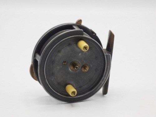 A Hardy Silex 3 1/4" bait casting reel, caged drum with twin ivorine handles, spring release latch and jewelled spindle bearing, brass foot, cut-away rim section and three rim mounted casting controls, light wear to lead finish only, circa 1910