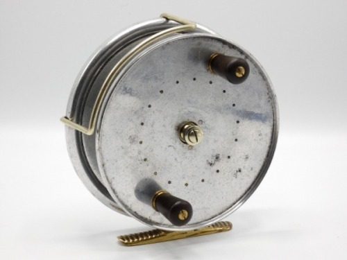 A scarce Hardy Longstone 6" sea centre pin reel, Duralumin construction, caged drum with twin reverse tapered ebonite handles and milled nickel silver drum tension nut, ribbed brass foot, nickel silver Bickerdyke line guide, rim mounted optional check lev