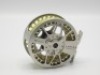 A Lamson Litespeed 2 Series IV trout fly reel, large arbour drum, skeletal frame, rear spindle mounted tension adjuster, light use only in neoprene pouch and card box and a Sage “One" 4 piece carbon trout fly rod, 9’, #5, wooden reel seat, screw grip fit - 2