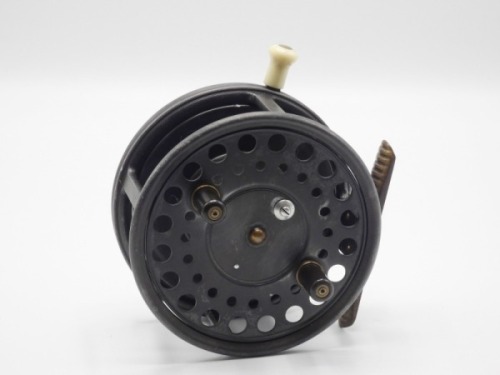 A good Hardy Silex Major wide drummed 4 1/2" bait casting reel, shallow cored drum with twin ebonite handles and spring release latch, ribbed brass foot, ivorine rim mounted casting trigger and milled nickel silver tension screw with rear ivorine quadrant