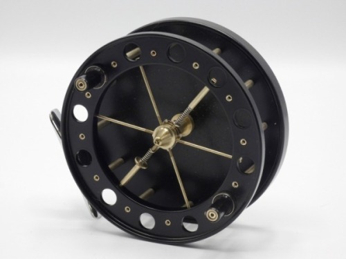 A Fred Crouch Match Aerial 4 1/2" wide drummed centre pin reel, black finish, caged and six spoked drum with twin composition handles, chromed foot, rear optional check button and bar spring check mechanism, as new condition and a Martin James 3 piece wh