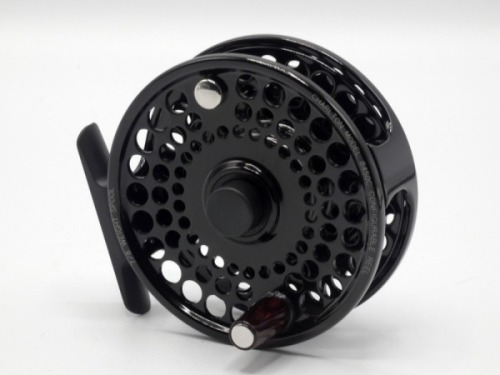 A fine Charlton 8450c Configurable #7/8 trout fly reel, left hand wind black anodised model with counter-balanced tapered rosewood handle, multi-perforated drum with push button release, rear spindle mounted tension adjusting wheel, reel is in new/unused