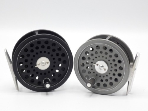 A Hardy Ultralite Disc #6 trout fly reel, composition handle, alloy foot, two screw drum latch, rear milled spindle mounted tension regulator and a Hardy JLH Ultralite #5 trout fly reel of similar design, both in as new condition and in zip cases (3)