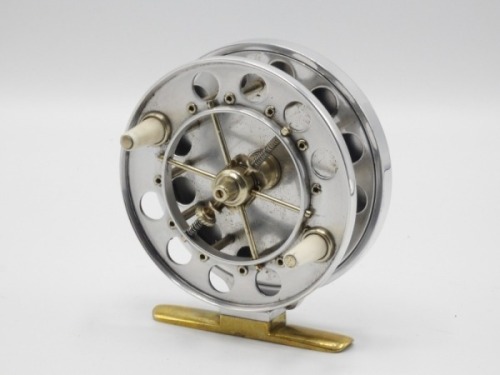 A Chris Henshaw Aerial style 3 1/2" narrow drummed centre pin reel, polished alloy caged and six spoked drum with twin tapered xylonite handles, ventilated front and rear flanges, twin release/regulator forks, brass stancheon foot, rear nickel silver slid