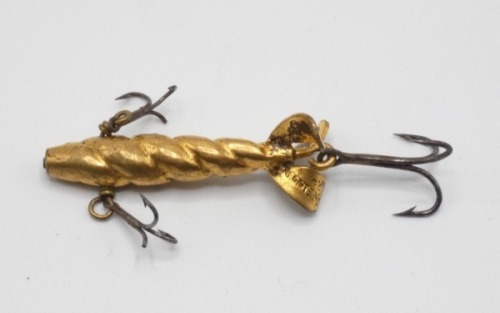 A James Ogden 1 1/2" Patent Spinner minnow bait, the gilt metal fish shaped lure with spiral fluted body, three rear spinning vanes, stamped makers details, two side mounted and one rear mounted treble hook, circa 1900 and a collection of twelve spoon an