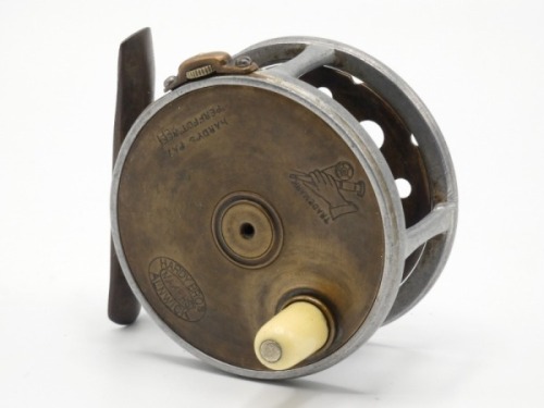 A rare Hardy Perfect Houghton Dry Fly Transitional Brass Faced 2 5/8" trout fly reel, ivorine handle, brass block foot, alloy cage with triple waisted pillars, strapped rim tension screw and early calliper spring check mechanism, open ball race with phos