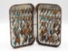 A good Hardy Neroda bakelite small salmon fly box, tortoiseshell finish, interior fitted nickel silver plates of 84 spring fly clips and holding a good selection of smaller fully dressed eyed salmon flies, 1940’s (see illustration)