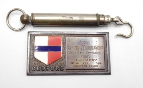 A rectangular bronze tournament casting plaque presented to H.J. Hardy (1887-1947) for the Bedford 1936 1/4oz Bait Distance competition, engraved details of the new First Place (European Record) of 80yds 2ft 7ins, with coloured enamel county badge to one 
