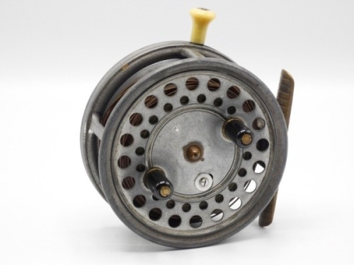 A Hardy Silex Major 4" bait casting reel, shallow cored drum with twin ebonite handles, spring release latch and jewelled spindle bearing, ribbed brass foot, rim mounted ivorine casting trigger and milled tension screw with rear ivorine quadrant weight i