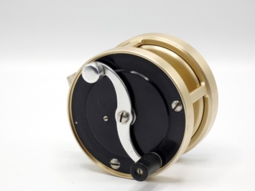 A rare S.E. Bogdan No.2 multiplying salmon fly reel, right hand wind model with black/champagne gold anodised finish, 2:1 ratio retrieve, counter-balanced “S" scroll handle, alloy foot, stamped model details, rear milled optional check button and ten poi